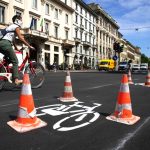 A cyclist passes a newly-marked cycle lane in Milan. © Bloomberg